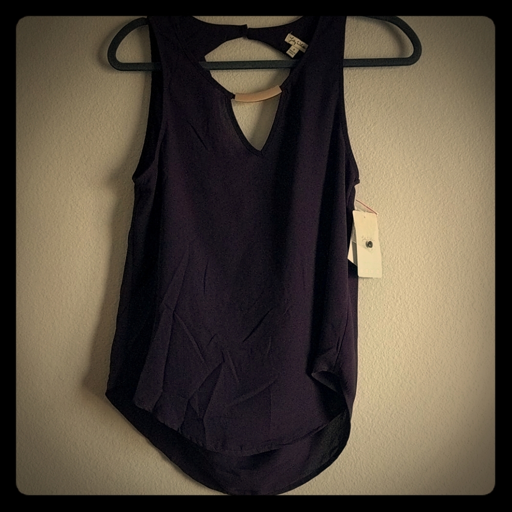 Eggplant/dark purple top with gold color piece.